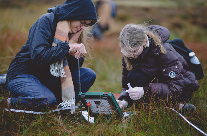 Geography students conducting soil science tests in the Peak District. 