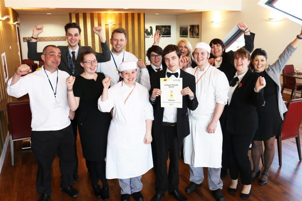 Level 3 Hospitality Supervision student Liam Ironmonger (centre) proudly holds the AA Rosette certificate, surrounded by staff and students of Refined