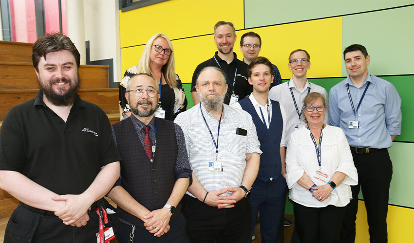 An image of various members of staff smiling at the camera.