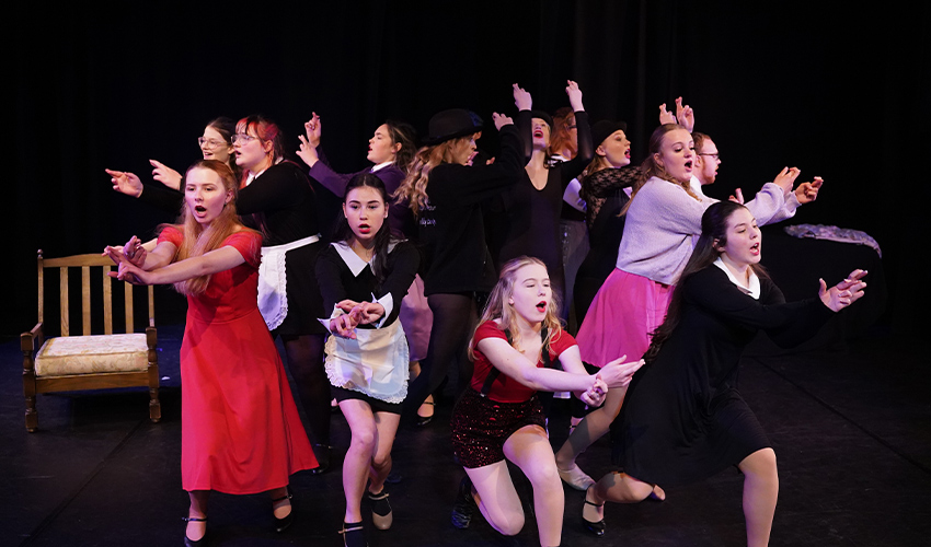 An image of a group of performing arts students performing a show.