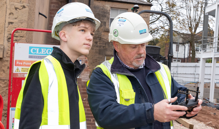 Engineering student with his employer on-site