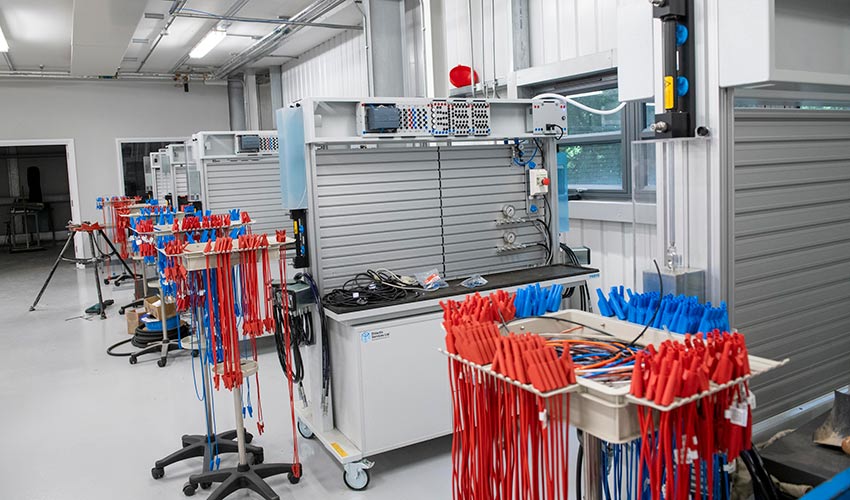 Organised tool storage areas with color-coded wrenches and equipment displayed on mobile carts and wall-mounted systems.