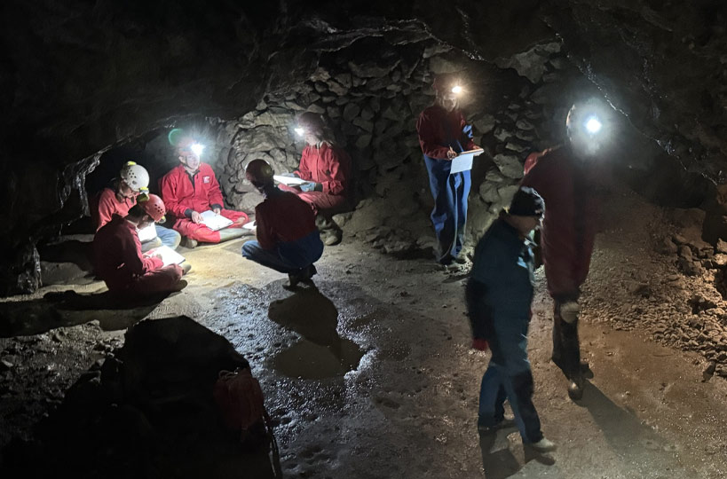 Students embarking on a caving expedition with a guest geologist.