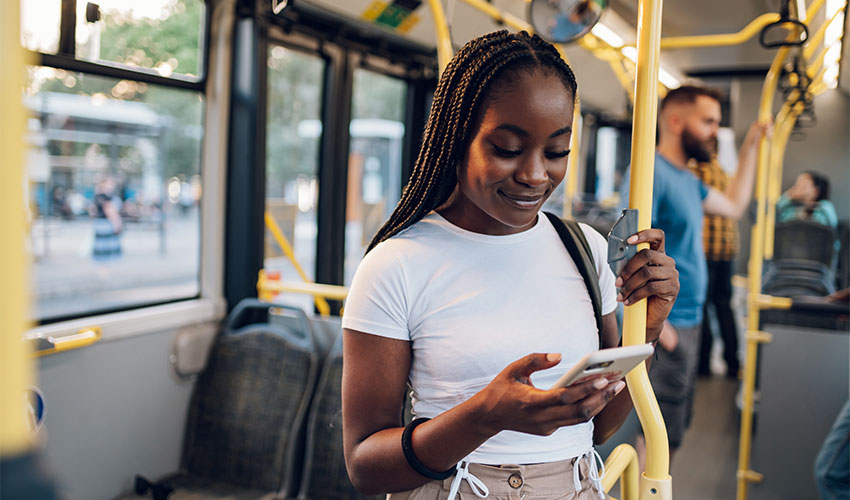 Student on the bus, using their phone