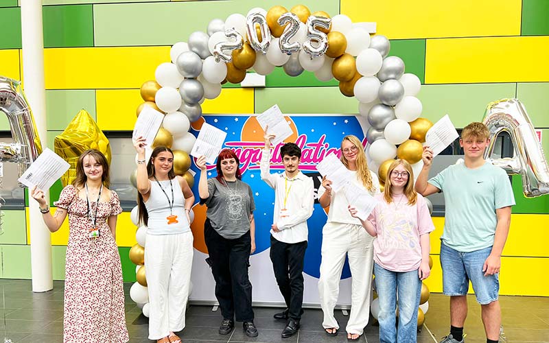 Students from the college celebrate their results.
