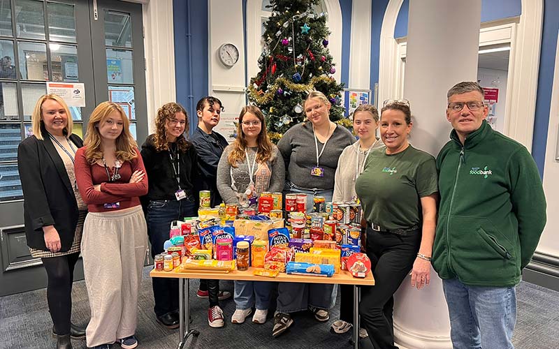 Dominika (centre), fellow students who supported the initiative, and curriculum area lead Julie Bott (left) with just some of the donated food, which was gratefully collected by Michelle Jennings and Chris Jewkes of Sherwood Forest Foodbank.