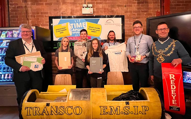 Construction students with some of the artefacts found inside the capsule