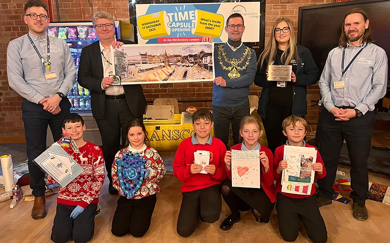 Pupils proudly show off their items with college staff and Mayor Andy Abrahams.