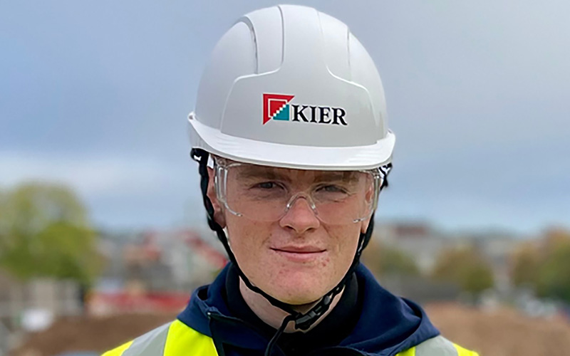 Former apprentice wearing a hard hat and safety goggles.