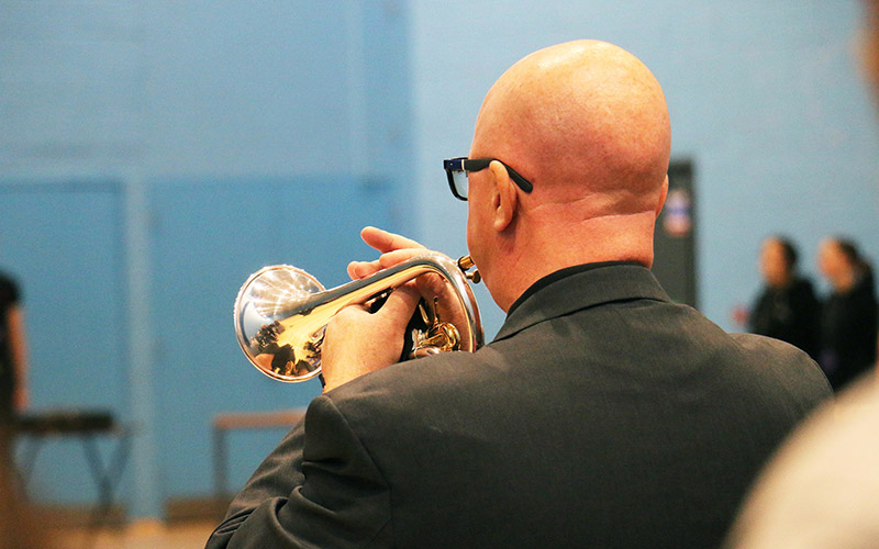 Former army musician and member of college staff Mike Kilmartin played the bugle