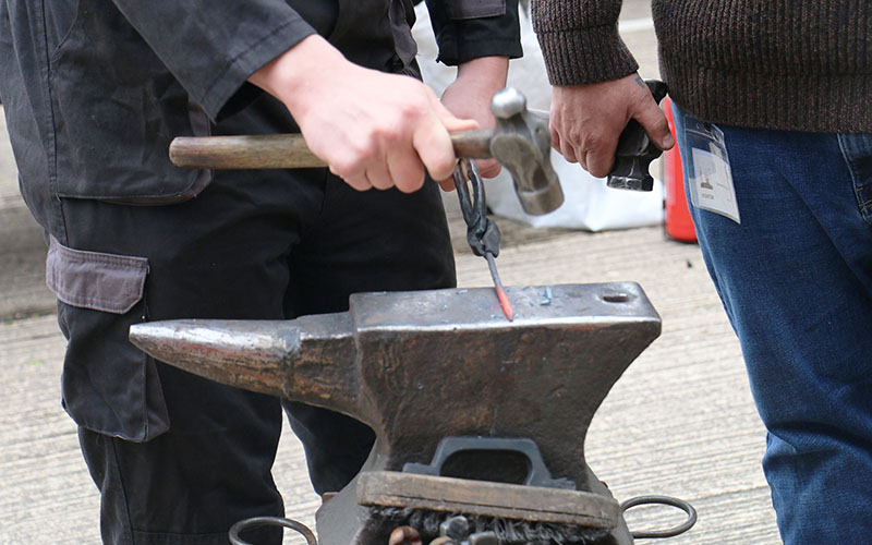 Hammer work creates the desired shape of the hot metal