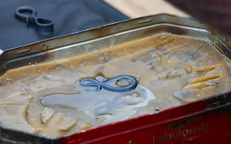 The tradition of placing the hot metal in bees wax gives it a darker colour