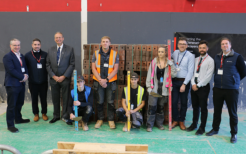 Representatives from Persimmon Homes and the college beside the generous brick donation.