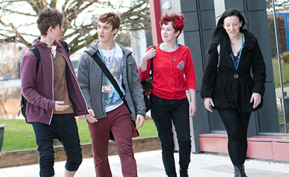 photo of four student walking
