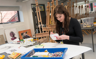 Image of a young woman in an art studio.