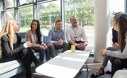 Image of a group of business students sitting down having a discussion