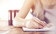 Young woman writing a letter