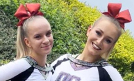 Image of two cheerleaders smiling towards the camera.