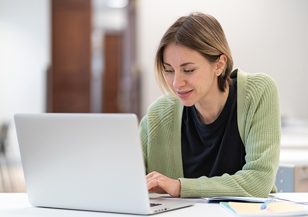 Image of a young women working on a laptop.