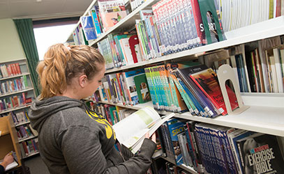photo of student reading a book in the learning resource learning centre