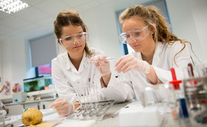 photo of two students conducting a science test