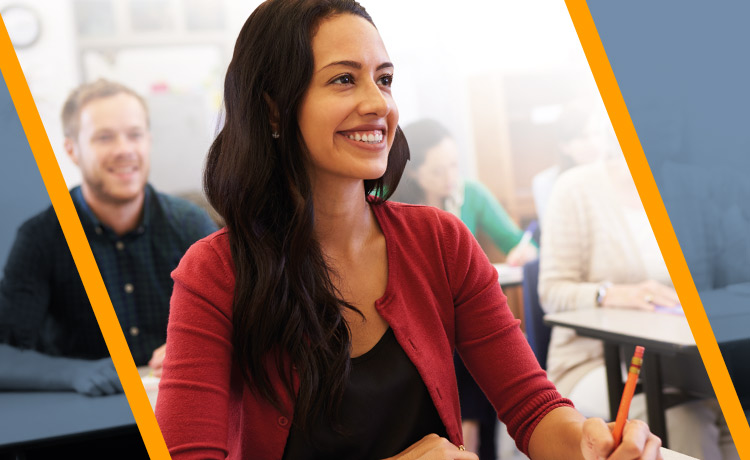 A young adult learner smiling towards a teacher.