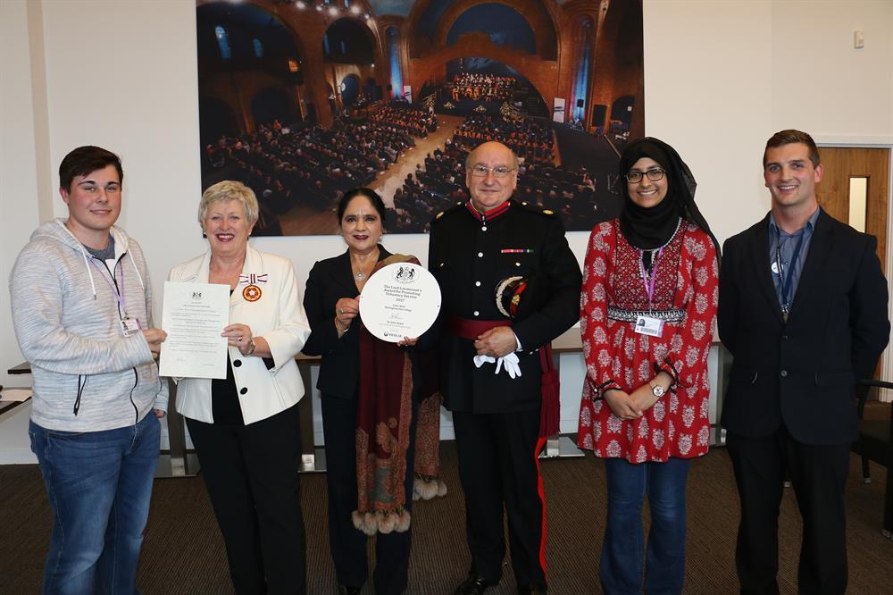 Dame Asha receives the plaque from Vice Lord-Lieutenant of Nottinghamshire Col. Tim Richmond OBE TD DL, while Deputy-Lieutenant Jean Pardoe OBE DL presents the certificate to Oliver Hughes. They are joined by Sarah Maqbool and Robert Pearce.