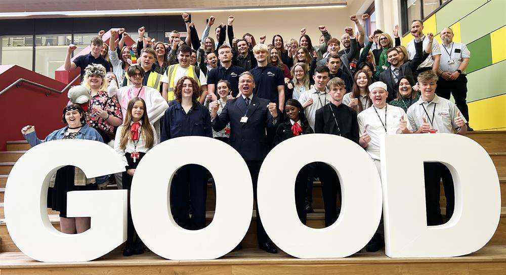  Students and staff join principal Andrew Cropley (front, centre) in celebrating the college’s Ofsted result.