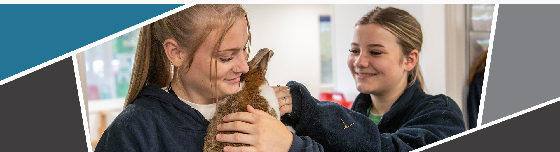 Image of 2 learners holding a bunny