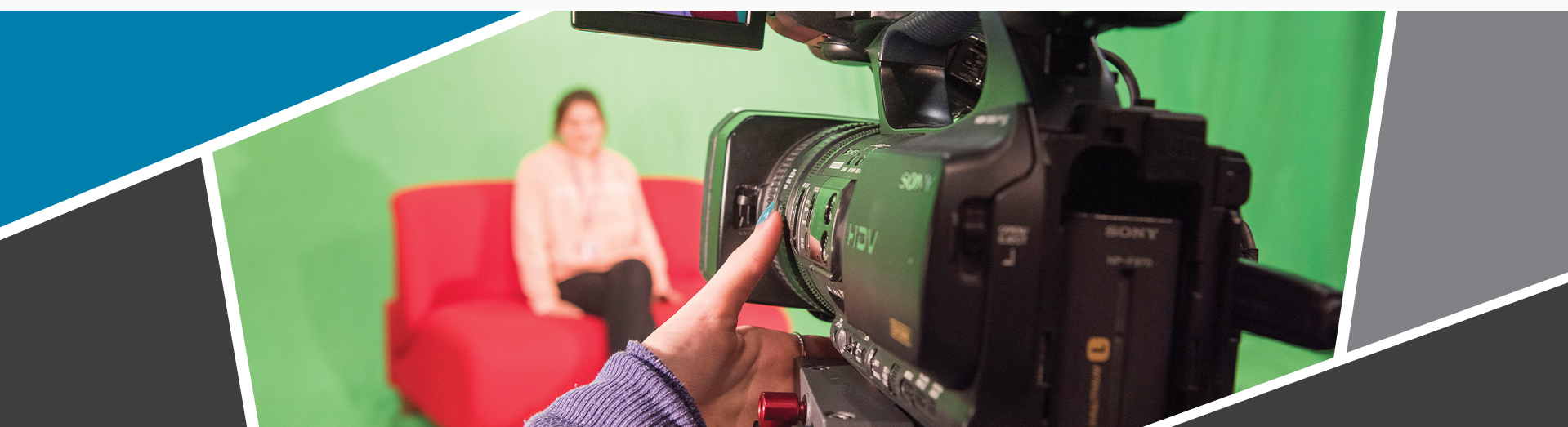 An image of a camera recording a student in a tv studio, with a big green screen behind.