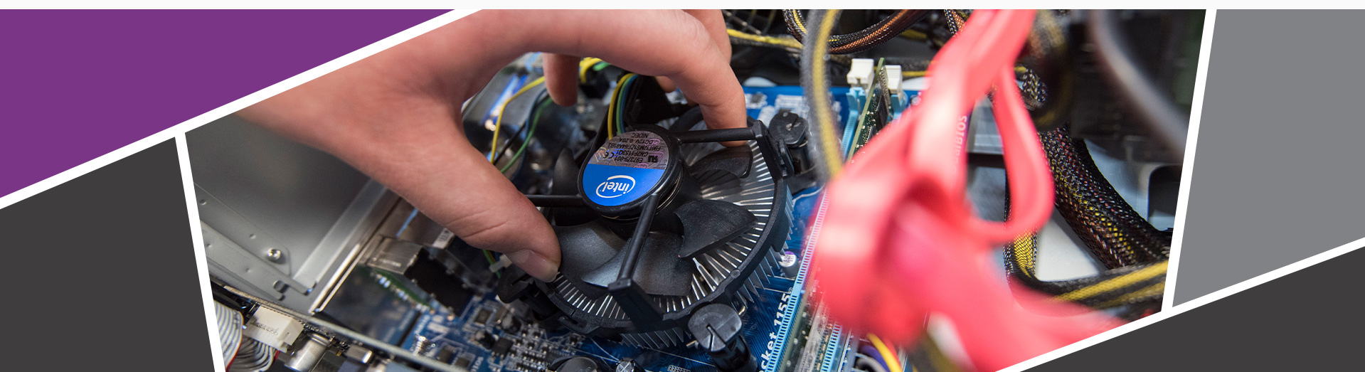 An image of a student building a pc, holding a component into place.