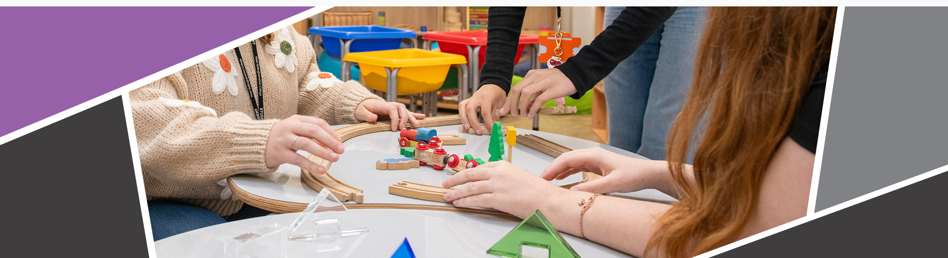 An image of 3 students using common children's toys found in a nursery.