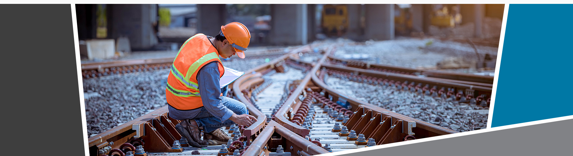 Man in high visibility vest and helmet working on a rail track.