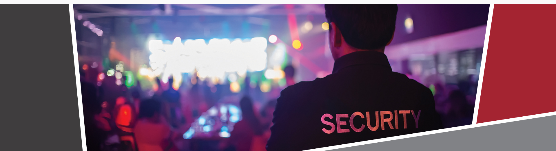 A man in a security jacket, standing in front of a club setting with lots of people and bright, colourful lights.