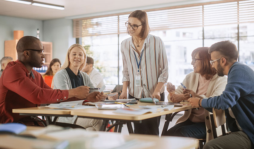 A group of mature learners having a conversation with their tutor