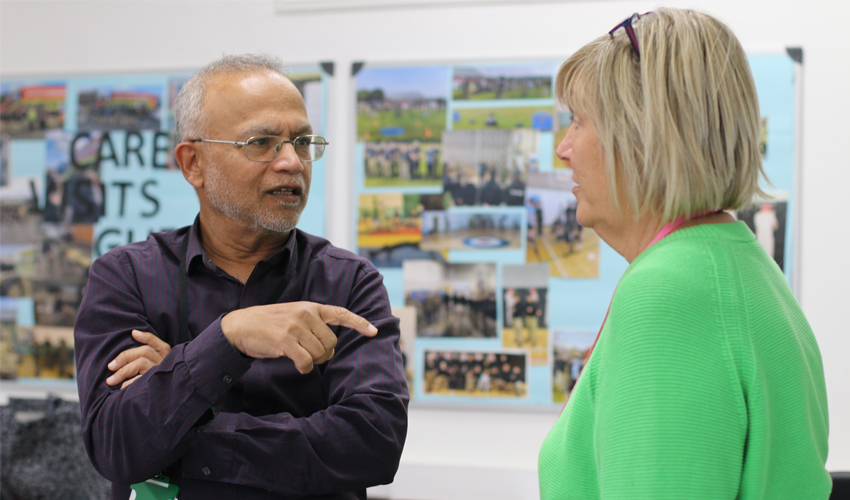 An image of an adult student talking to a tutor.