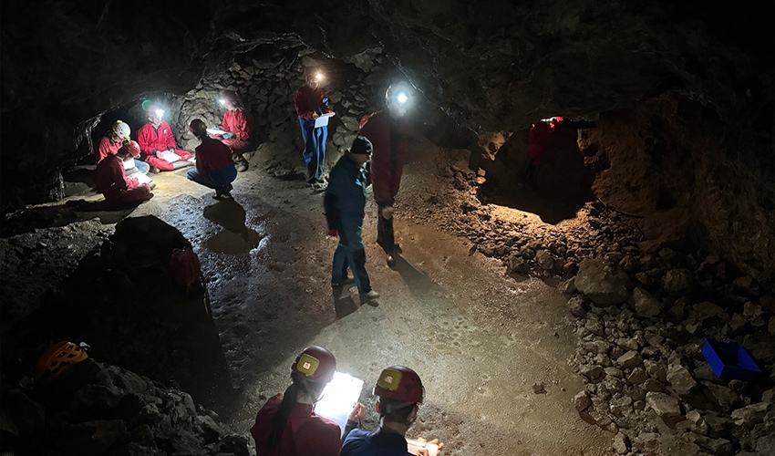 Embarking on a caving expedition with a guest geologist.