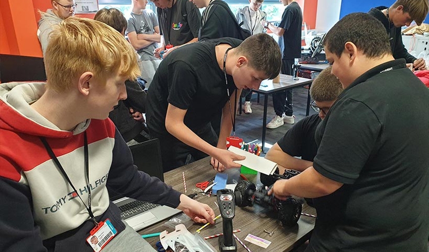 Students worked together setting up cars for a radio-controlled car grand prix.